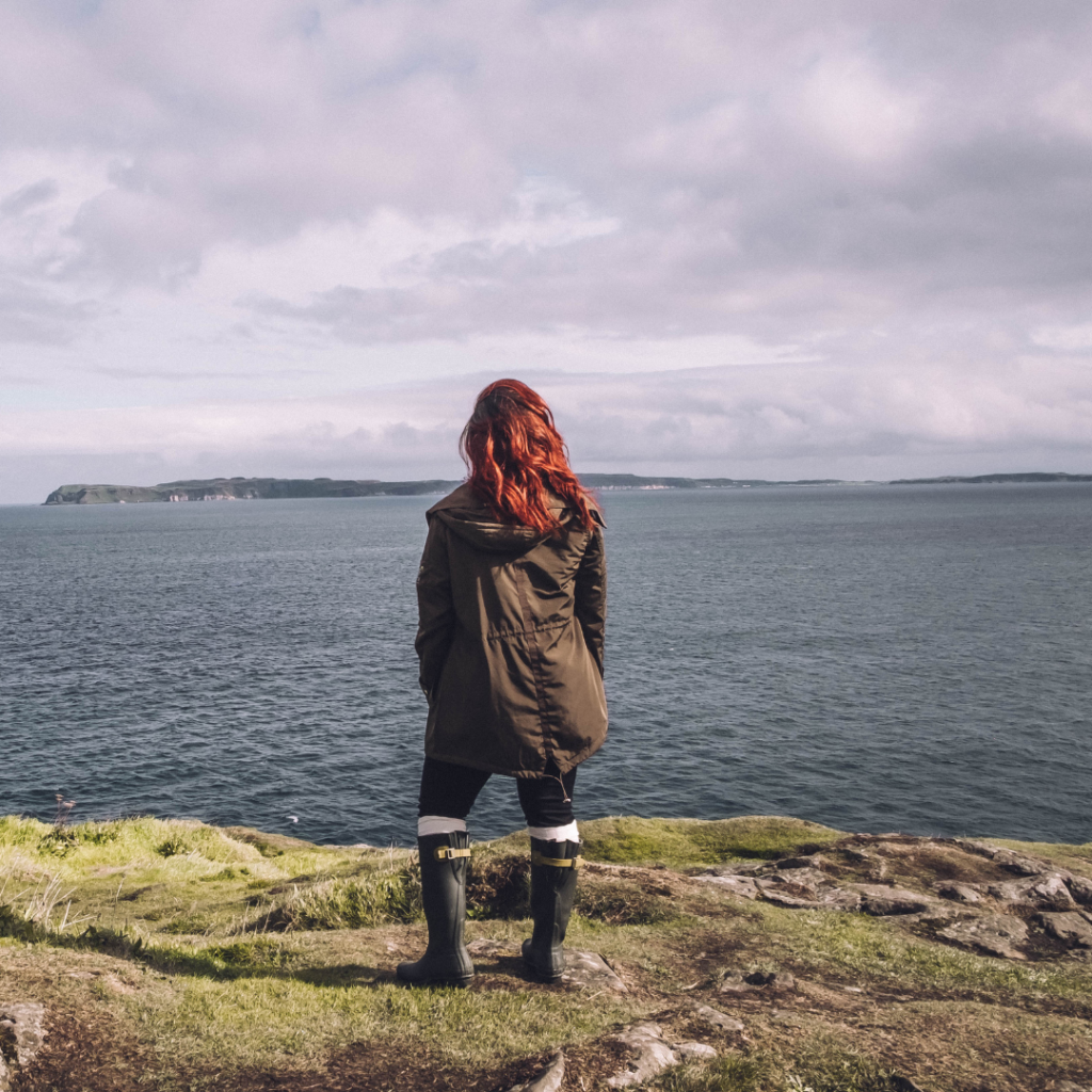 Solo Women on a cliff in Ireland 